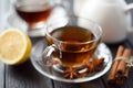 Hot autumn drink. Black tea served with lemon, cinnamon and star Royalty Free Stock Photo