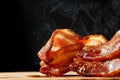 Hot Bacon With Steam Isolated on Black