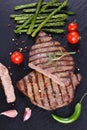 Hot barbecued beef steaks with vegetables Royalty Free Stock Photo