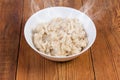 Hot barley porridge in bowl on the rustic table Royalty Free Stock Photo