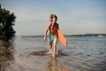 Hot beach lifeguard running along the river bank with life-saving equipment Royalty Free Stock Photo