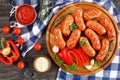 Hot beef sausages on round cutting board Royalty Free Stock Photo