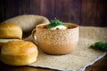 Hot beetroot soup with sour cream, herbs and rolls in a ceramic bowl Royalty Free Stock Photo