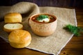 hot beetroot soup with sour cream, herbs and rolls in a ceramic bowl Royalty Free Stock Photo