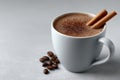 Hot beverage in a mug with cinnamon sticks and coffee beans Royalty Free Stock Photo