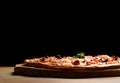 Hot big pepperoni pizza tasty pizza composition with melting cheese bacon tomatoes ham paprika Royalty Free Stock Photo