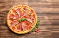 Hot big pepperoni pizza tasty pizza composition with melting cheese bacon tomatoes ham paprika Royalty Free Stock Photo