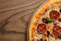 Hot big pepperoni pizza tasty pizza composition with melting cheese bacon tomatoes ham paprika steam smoke Royalty Free Stock Photo