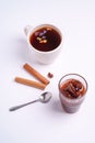 Hot black aromatic tea near to fig jam, Christmas breakfast mood with anise and cinnamon on white background Royalty Free Stock Photo
