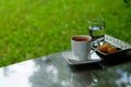 Hot black coffee or hot American coffee in white cup Served with Met Khanoon Golden Jackfruit Seeds Thai Mung Bean Marzipan and E