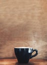 Hot black coffee cup cappuccino on wood table with wood wall.leave copy space for adding text Royalty Free Stock Photo
