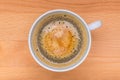 Hot black coffee with foam bubbles in white cup with wooden boar Royalty Free Stock Photo