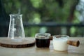 Hot black coffee  and fresh milk in mini transparent glass cup Royalty Free Stock Photo