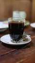 Hot black coffee in a traditional Javanese glass called starfruit glass or gelas belimbing