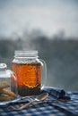 Hot black tea jar on a frosty winter day, window background