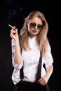 Hot blonde woman smoking on black background Royalty Free Stock Photo