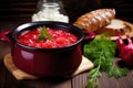 hot borscht in a bowl sitting on rustic wooden table Royalty Free Stock Photo