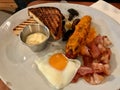 Hot Breakfast Plate with Sausage, Fried Egg , Bacon and Toast Bread / English Style.