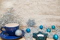 Hot chocolate in blue cup, silver Christmas decoration. Royalty Free Stock Photo