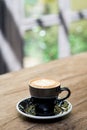 Hot cappuccino coffee cup with tree shape latte art milk foam on Royalty Free Stock Photo