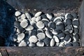 Hot charcoal briquettes in chargrill or garden grill Background texture of hot coals, close-up, top view. Burning briquettes Royalty Free Stock Photo