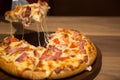 Hot cheese pizza in dinner light on wood table Royalty Free Stock Photo