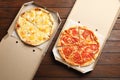 Hot cheese pizzas in cardboard boxes on table, top view. Food delivery service Royalty Free Stock Photo