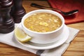 Hot chicken Corn Soup with lime slice served in a dish isolated on table side view of middle east food