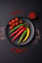 Hot chili peppers of three different colors red, green and yellow Royalty Free Stock Photo