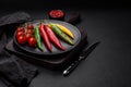 Hot chili peppers of three different colors red, green and yellow Royalty Free Stock Photo