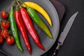 Hot chili peppers of three different colors red, green and yellow Royalty Free Stock Photo