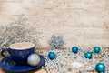 Hot chocolate in blue cup, silver Christmas decoration. Royalty Free Stock Photo