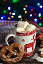 Hot chocolate or cocoa beverage with cinnamon and gingerbread cookies in snow vintage wooden table background. Royalty Free Stock Photo