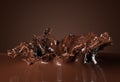 Hot chocolate or cocoa drink splash over brown background