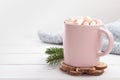 Hot chocolate cocoa with marshmallows in a pink cup on a white wooden background Royalty Free Stock Photo