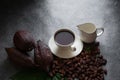 Hot chocolate and Cocoa pod cut exposing cocoa seeds on dark table, top view with copy space Royalty Free Stock Photo