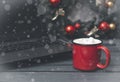 Hot chocolate or coffee and marshmallows next to a gray laptop, spruce Christmas wreath with red balls on a gray background with Royalty Free Stock Photo