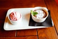 Hot chocolate cupcake fondant with scoop or ball of strawberry ice cream on wooden table. Close-up, top view Royalty Free Stock Photo