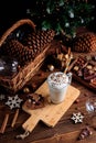 Hot chocolate drink with whipped cream. Cozy Christmas composition on a dark wooden background. Sweet treats for cold Royalty Free Stock Photo