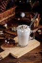 Hot chocolate drink with whipped cream. Cozy Christmas composition on a dark wooden background. Sweet treats for cold Royalty Free Stock Photo