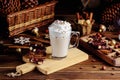 Hot chocolate drink with whipped cream. Cozy Christmas composition on a dark wooden background. Sweet treats for cold Royalty Free Stock Photo