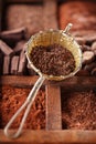 Hot chocolate flakes in old rustic style silver sieve on wooden Royalty Free Stock Photo