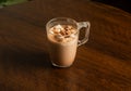 hot chocolate glass mug with marsmallow candies isolated on dark wooden table Royalty Free Stock Photo