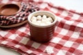 hot chocolate in a handmade clay mug on a quilting mat