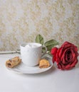 Hot chocolate with long stemmed red rose Royalty Free Stock Photo