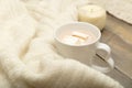 Hot chocolate, marshmallow, knitted, warm plaid on a wooden back Royalty Free Stock Photo