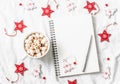 Hot chocolate with marshmallows and cinnamon, clean blank notepad, christmas decorations on a light background. Christmas inspirat