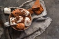 Hot chocolate and marshmallows. Hot Cocoa in a white cup. Dark background. Autumn drink concept. Copy space. Top view