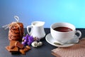 Hot chocolate and milk, cup of cocoa, chocolate cookies, almonds, flowers on a shale board on bright blue background, place to cop Royalty Free Stock Photo