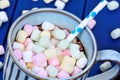 Hot chocolate with mini colorful marshmallow in a cup on table